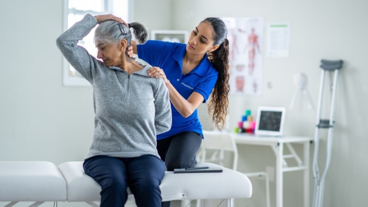 PNF Proprioceptinis Neuromuskulinis Palengvinimo Tempimas. Specialistė taiko pacientei PNF tempimo techniką.