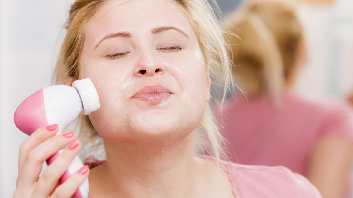 Veido Valymo Šepetėlio Prietaisas (Face Cleaning Brush Device). Mergina atlieka veido valymo procedūra.