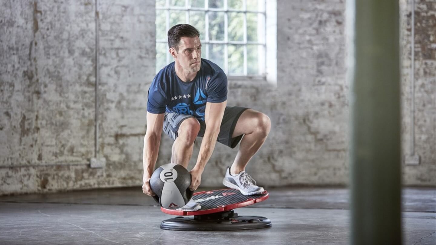 „Reebok“ pagrindinė plokštė (Reebok Core Board). Sportininkas mankštinasi ant Reebok Core Board.